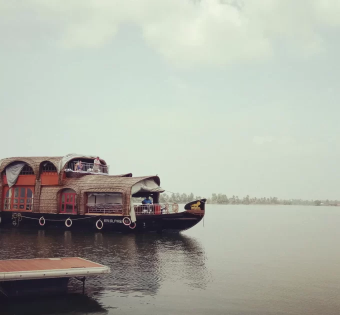 A scenic view of a houseboat balcony overlooking the tranquil backwaters of Alleppey, Kerala