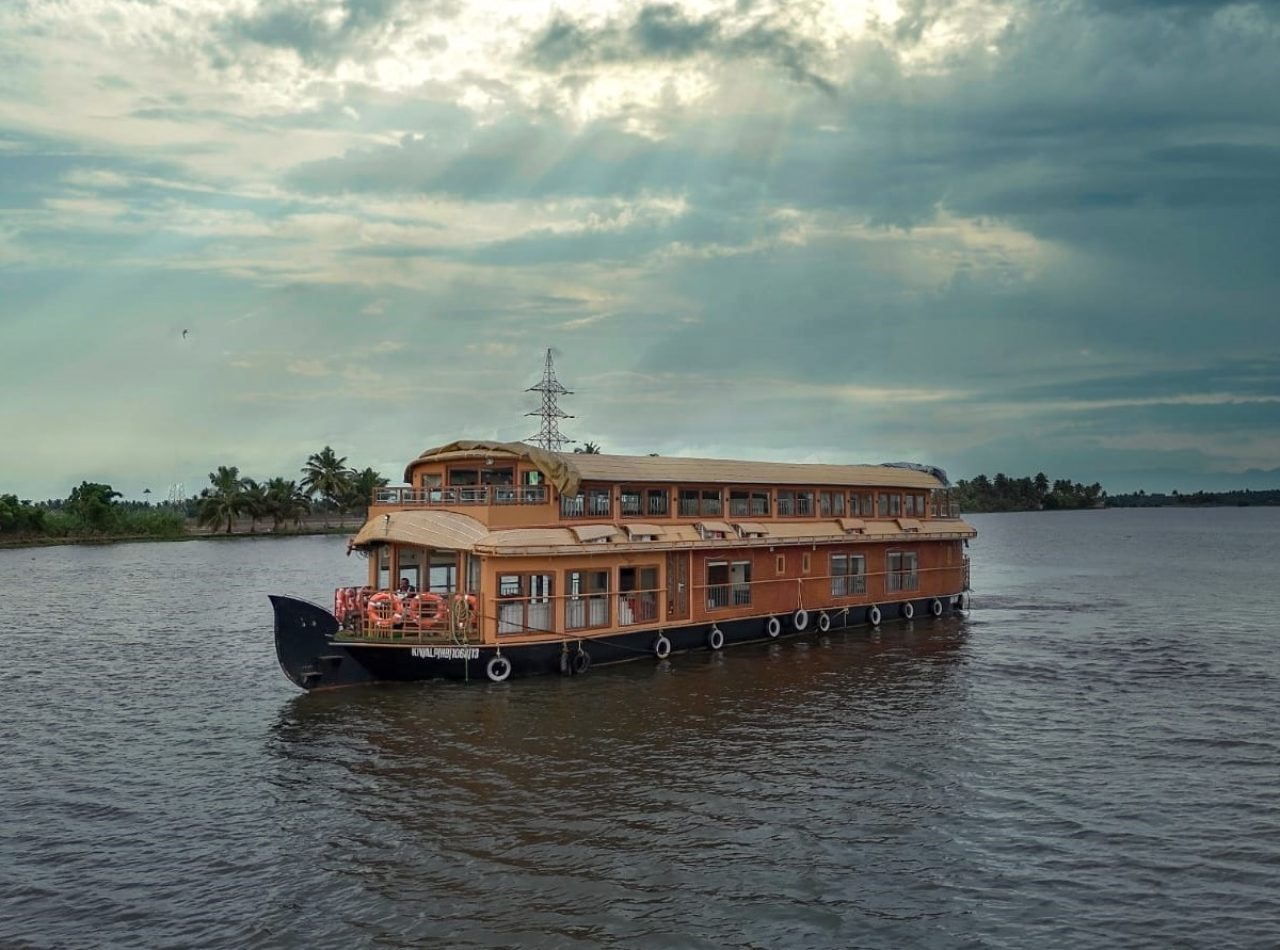 A Deluxe houseboat in Alleppey with traditional architecture and modern amenities.